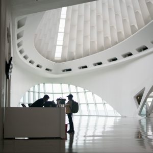 Security guard at a front desk reception area providing help to visitor