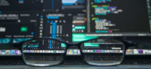 Glasses in front of computer screens which show security technology